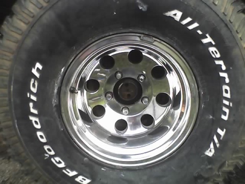 1979 Ford F-150 - Close-up of a BFGoodrich All-Terrain T/A tire mounted on a chrome wheel.