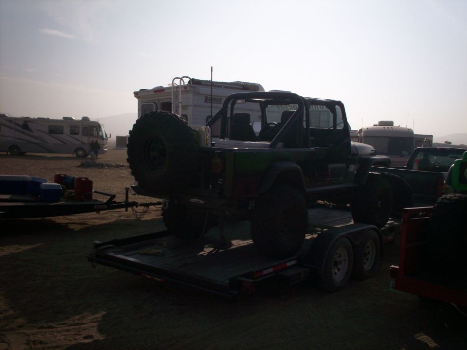 Jeep Wrangler on a trailer with RVs in the background