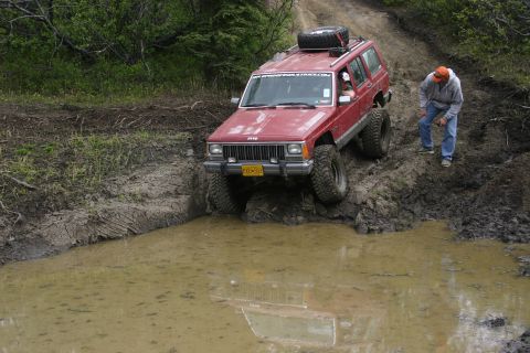 2003 Jeep TJ - Jeep Cherokee XJ tackles a challenging muddy off-road course.