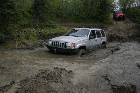 2003 Jeep TJ - Two Jeeps tackle a challenging muddy off-road course.