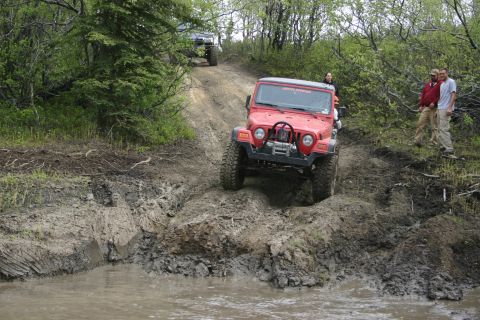 2003 Jeep TJ - Two Jeeps tackle a challenging muddy off-road course.