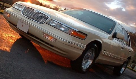 1996 Mercury Grand Marquis - A 1996 Mercury Grand Marquis is captured in a three-quarter front view during a sunset.