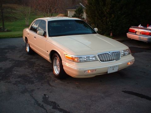 1996 Mercury Grand Marquis - A 1995 Mercury Grand Marquis is parked outside on a driveway, with another vehicle in the background.