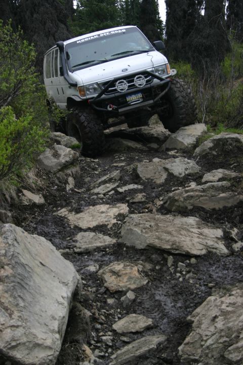 2003 Jeep TJ - Modified van tackling a challenging rocky path off-road.