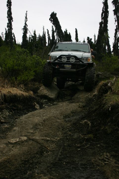 2003 Jeep TJ - Jeep TJ tackling rough terrain on an off-road trail.