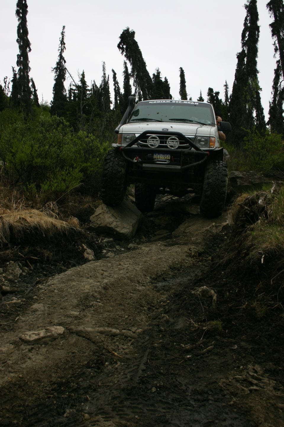 2003 Jeep TJ navigating a rocky trail with snorkel and aftermarket bumper