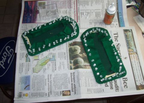 1994 Ford F-150 - Two green fabric items are laid out on a newspaper, surrounded by craft supplies.