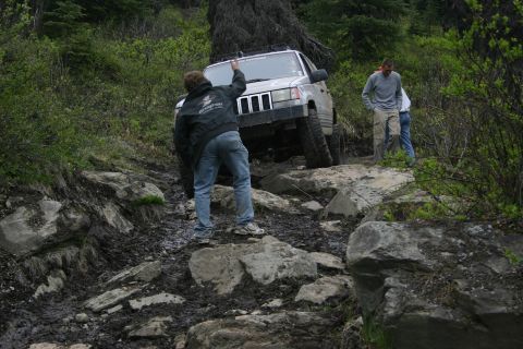 2003 Jeep TJ - Off-roading event with a Jeep Grand Cherokee tackling a challenging trail.