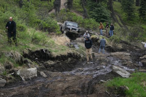 2003 Jeep TJ - A Jeep TJ tackles a challenging off-road course with onlookers present.