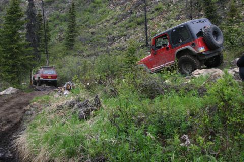 2003 Jeep TJ - Two Jeeps navigate a challenging off-road trail during an Alaska meet and greet.