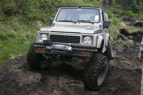 2003 Jeep TJ - This off-road SUV, equipped with a winch, navigates a challenging rocky trail.