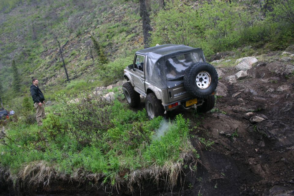 Suzuki Samurai on a muddy trail, rear view