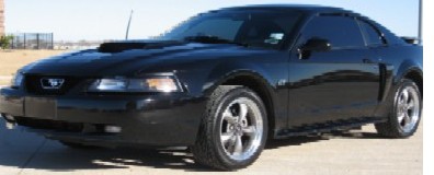 1986 Ford Bronco - Front 3/4 view of a black 2003 Ford Mustang coupe.