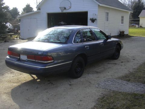 1996 Ford Crown Victoria - This 1996 Ford Crown Victoria sedan is parked in a driveway next to a garage.