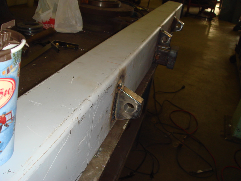 Gray metal bumper section with welded brackets and holes