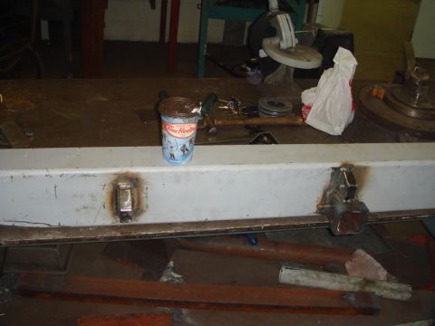 1996 Ford Bronco - Metal bar with hitch receiver and a Tim Hortons cup on a workbench.