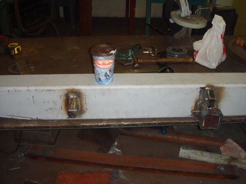 1996 Ford Bronco - A white bumper with welded tow hitch receivers and a Tim Hortons cup on top, likely in a workshop.