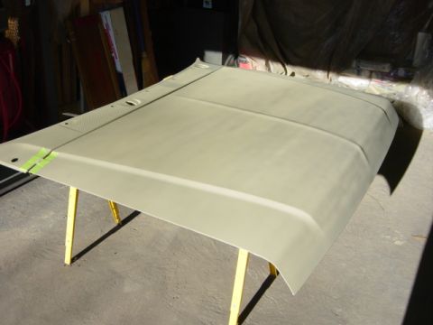 1991 Ford Bronco - A car hood is shown on sawhorses, ready for paint.