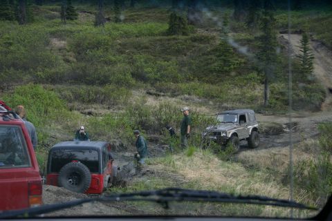 2003 Jeep TJ - Off-road vehicles navigate a muddy trail during an Alaska 4x4 Meet & Greet event.
