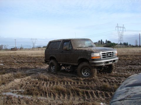 1996 Ford Bronco - This 1996 Ford Bronco is shown navigating a challenging muddy terrain.