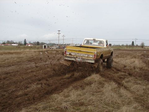 1996 Ford Bronco - Pickup truck navigating a challenging muddy terrain.