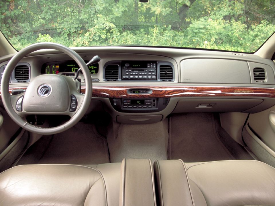 Mercury sedan interior with woodgrain dash, tan leather seats and column shifter shot from rear
