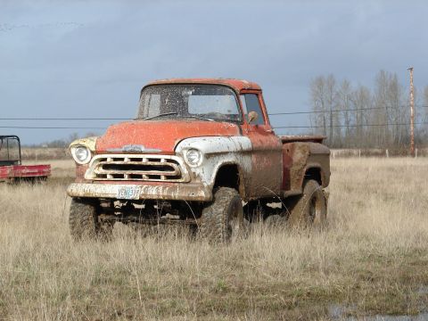 1996 Ford Bronco - This vintage Chevrolet pickup truck, likely from the mid-1950s, is shown caked in mud after an off-road excursion.