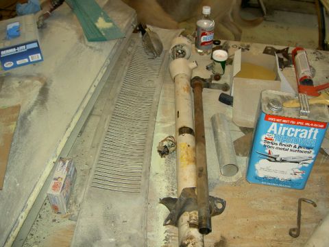 1967 Ford Ranchero - Automotive parts and chemicals including a steering column and a can of Aircraft Remover.