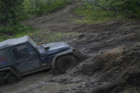 2003 Jeep TJ - A 2003 Jeep TJ struggles through a challenging muddy off-road course.