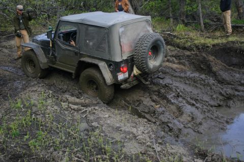 2003 Jeep TJ - A 2003 Jeep TJ navigates a challenging muddy off-road course during an Alaska 4x4 Meet & Greet event.