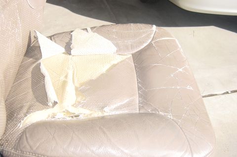 1996 Ford Bronco - The seat bottom panel is badly torn.