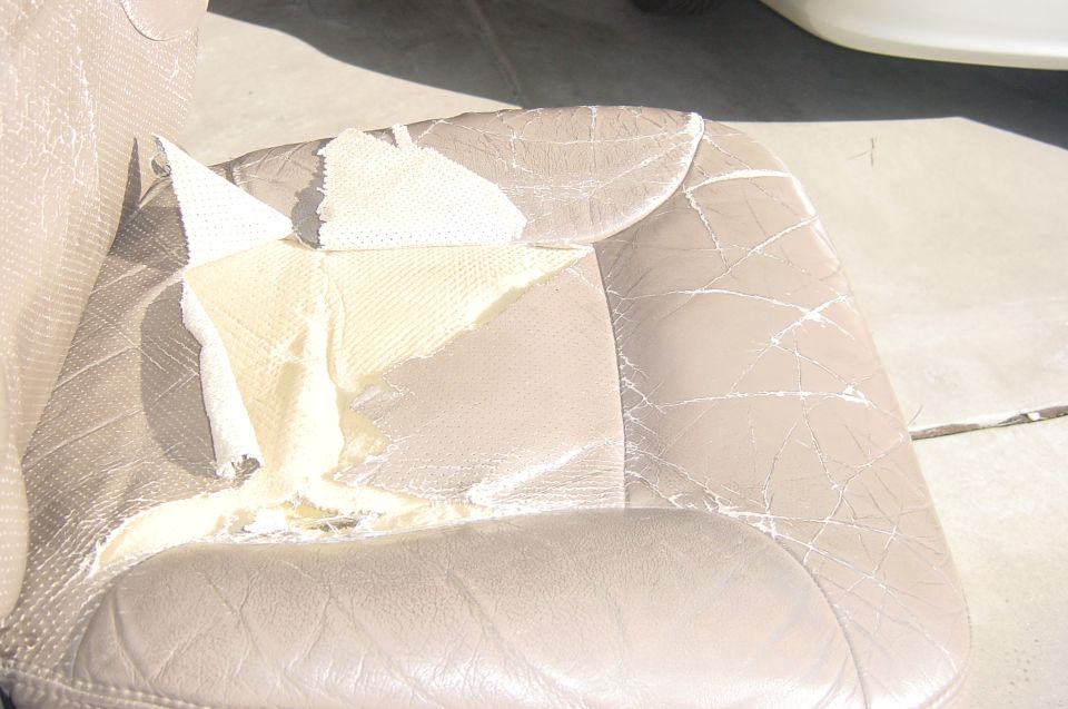 The seat bottom panel is badly torn.