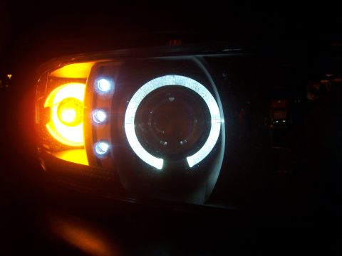 2001 Dodge 1500 - Custom projector headlights feature white halo rings and an amber turn signal light.