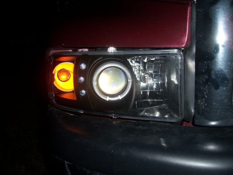 2001 Dodge 1500 - Close-up of a custom projector headlight assembly with halo lighting.