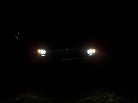 2001 Dodge 1500 - The front of a truck is illuminated by its headlights in the dark.