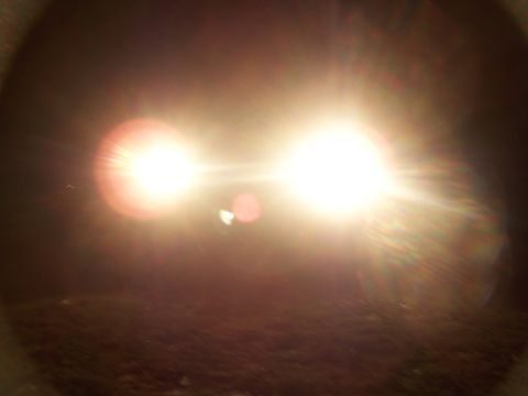 2001 Dodge 1500 - Headlights illuminate the darkness, creating a bright glare.