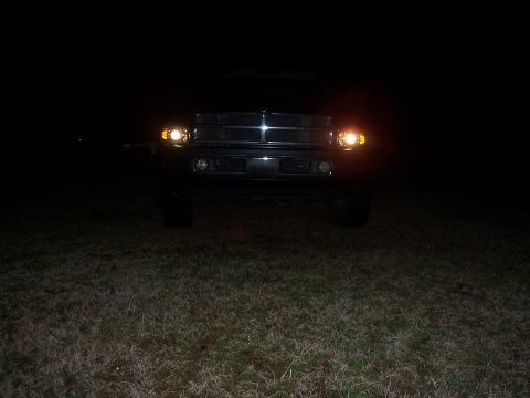 2001 Dodge 1500 - Front view of a 2001 Dodge 1500 pickup truck at night with its headlights illuminated.