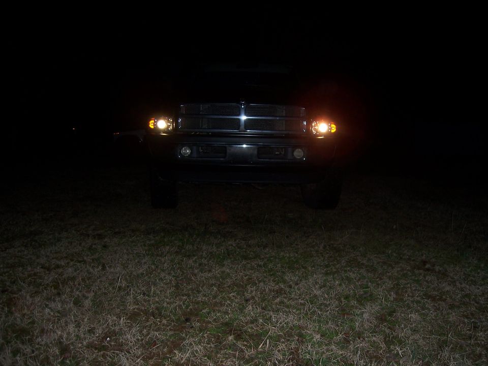 2001 Dodge 1500 front view with headlights on at night