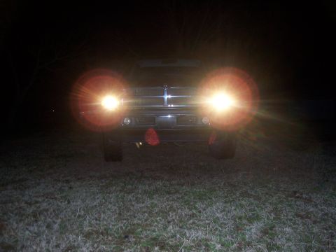 2001 Dodge 1500 - Front view of a black truck at night with its headlights illuminated.