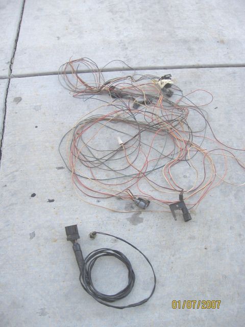 1994 Ford Bronco - A collection of vehicle wiring harnesses lies on a concrete surface, with a date stamp of 01/07/2007 visible.