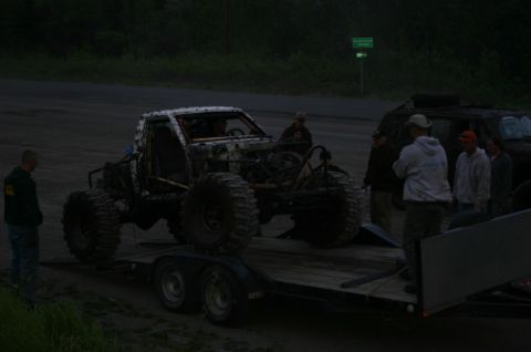 2003 Jeep TJ - Custom off-road vehicle being transported on a trailer with a group of people nearby.