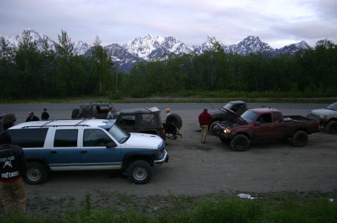 2003 Jeep TJ - Off-road vehicles gathered with a scenic mountain backdrop.