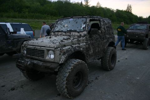 2003 Jeep TJ - Several off-road vehicles covered in mud after an event.