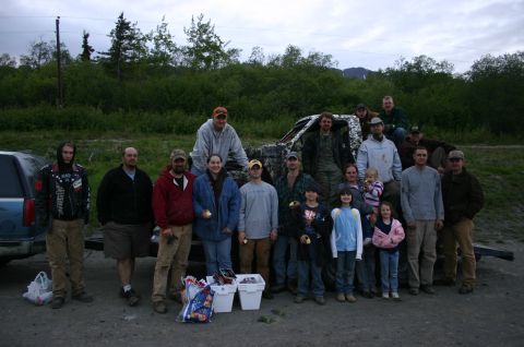 2003 Jeep TJ - A group of people gathered outdoors with two vehicles, one appearing damaged.