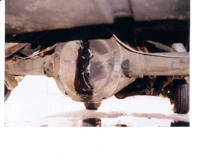 Rear differential housing with a large hole and leaking gear oil under a vehicle