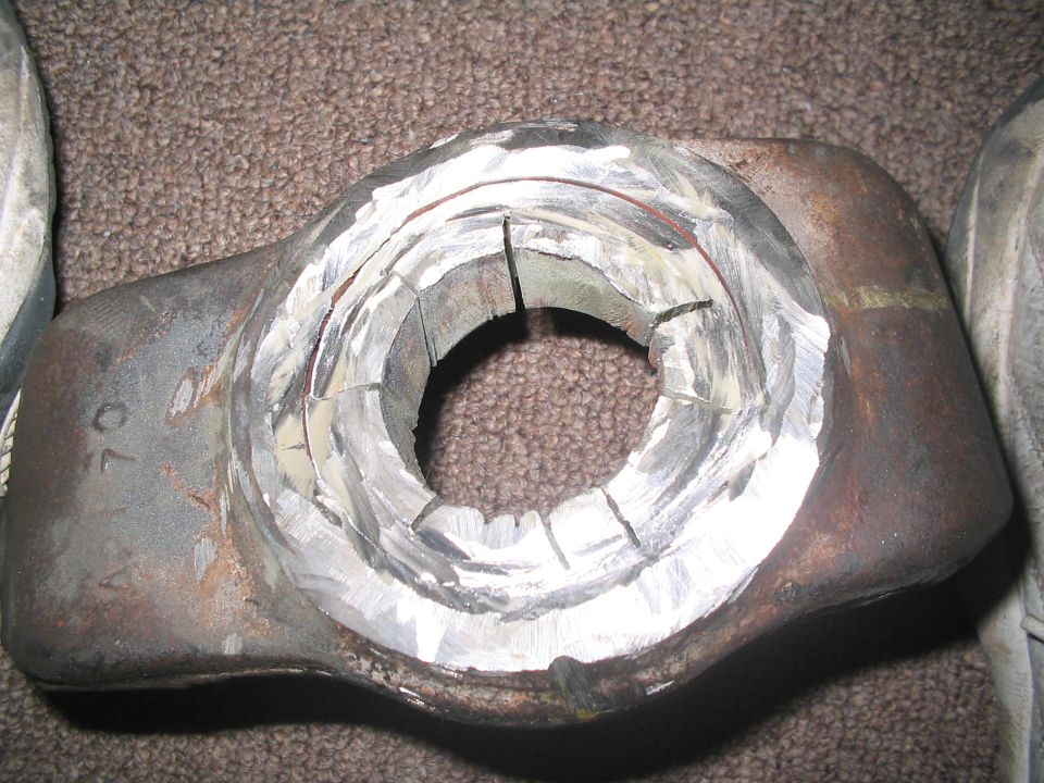 Metal part with machined circular opening and visible '70' marking