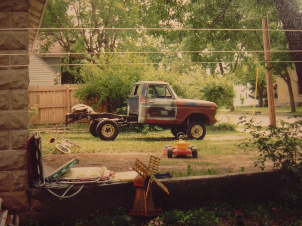 1977 Ford F-150 chassis with cab, side view, primer and red paint