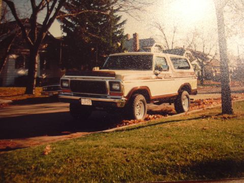 1977 Ford F-150 - This 1978 Ford Bronco is parked curbside on a street lined with trees and houses.
