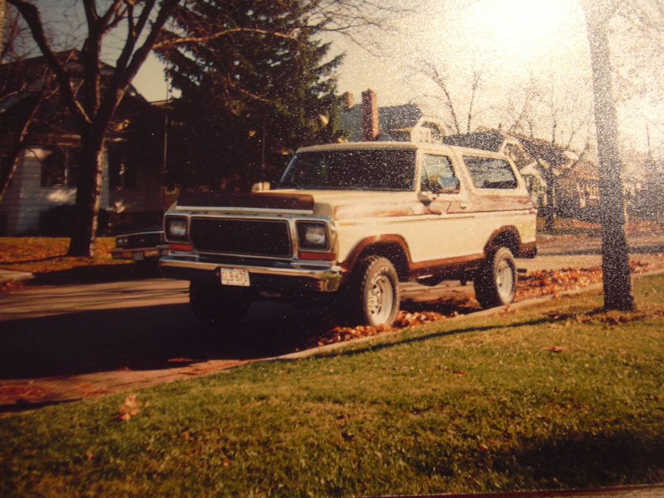 1978 Ford Bronco parked on a residential street with autumn leaves on the ground