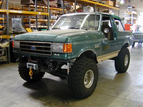 1989 Ford Bronco - This lifted 1989 Ford Bronco features aggressive off-road tires and a prominent winch on the front bumper.